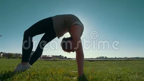 在青草上做瑜伽的女人视频的预览图