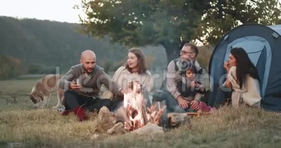 令人惊奇的是两个家庭在篝火旁开着帐篷野餐他们围坐在一起视频的预览图