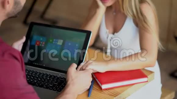 漂亮的女人和她的男朋友手牵手她的男朋友在笔记本电脑上工作视频的预览图