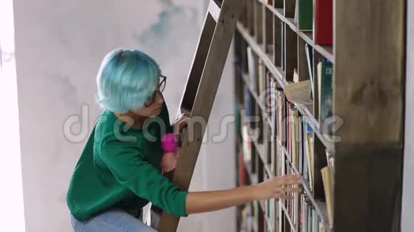 站在梯子上的女孩在图书馆找书视频的预览图