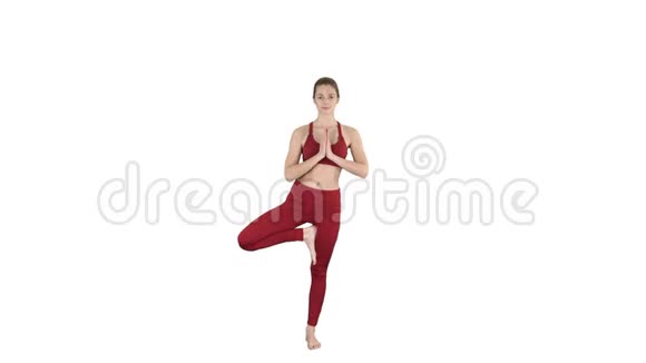 年轻女子练习瑜伽站在UtthitaHastaPadangustasana锻炼身体伸出手在白色的大脚趾上摆姿势视频的预览图