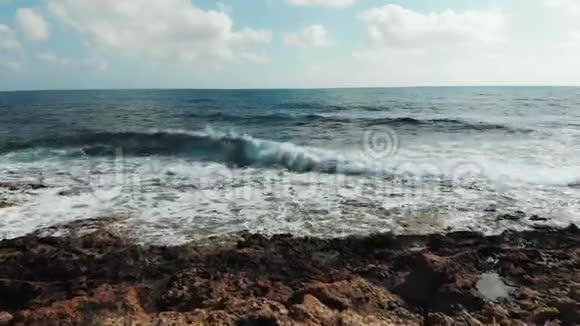 强海浪撞击岩石海滩的无人机景洛矶海滨海浪拍打形成泡沫和飞溅视频的预览图
