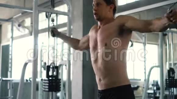 在健身房做交叉胸肌锻炼的肌肉男视频的预览图