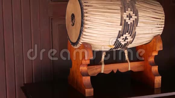 传统的架子鼓传统的泰国鼓装饰物放置在靠近木材墙的木架上视频的预览图