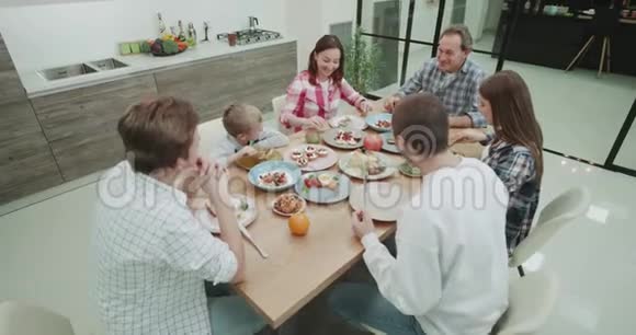 大家庭一起吃一顿健康的饭在现代厨房里拍摄视频拍摄红色史诗视频的预览图