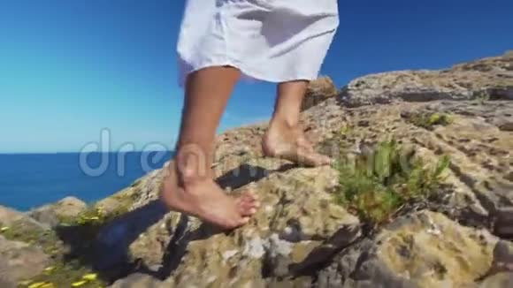 裸露的雌性腿在岩石地形上行走视频的预览图