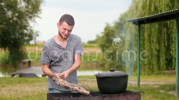 人们在野餐时在烤架上准备食物美丽的自然视频的预览图