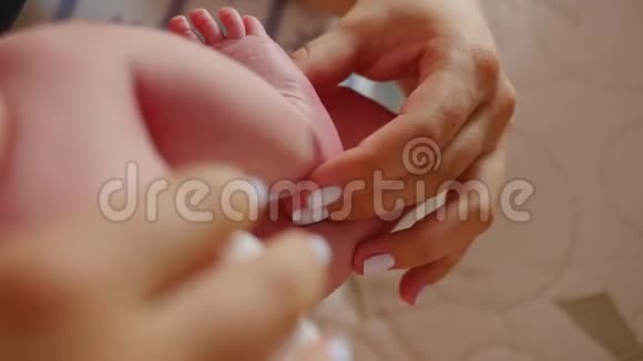 宝宝的脚在妈妈手里小新生婴儿脚在女性心脏整形的手特写妈妈和她的孩子快乐视频的预览图