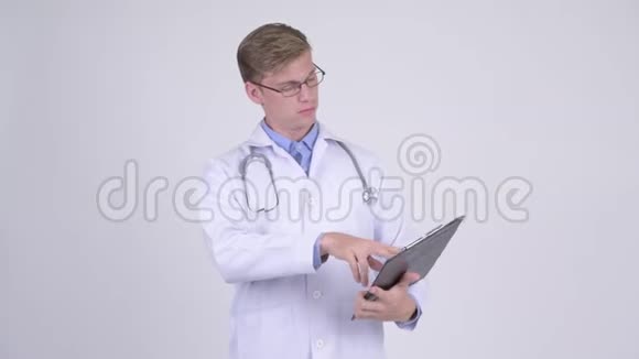 快乐的年轻人医生在剪贴板上看书竖起大拇指视频的预览图