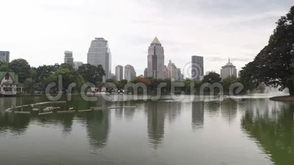 兰皮尼公园里有喷泉和绿树的大湖从城市公园俯瞰曼谷市中心视频的预览图