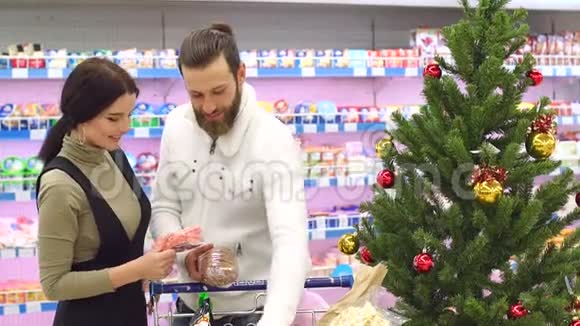 快乐的一对夫妇在杂货店买圣诞食品视频的预览图