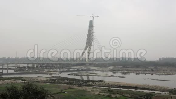 在阴天气下亚穆纳河上正在施工的斜拉桥签名桥印度视频的预览图