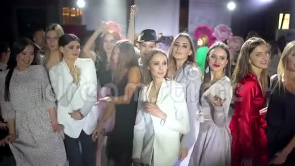 派对快乐笑容可掬的年轻一群人美女模特女友带着迪斯科灯在夜总会为视频的预览图