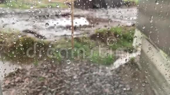 窗户上的雨滴一滴水在玻璃上翻滚视频的预览图