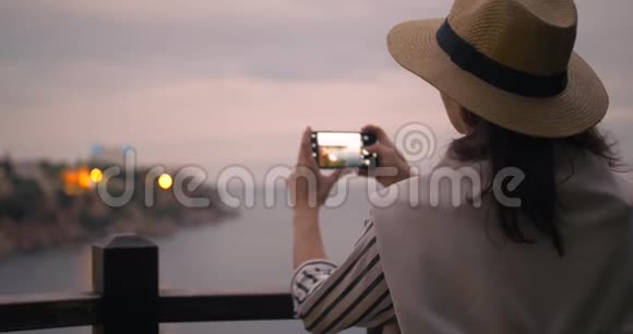 穿着休闲服装用智能手机拍照城市港湾的千禧女游客视频的预览图