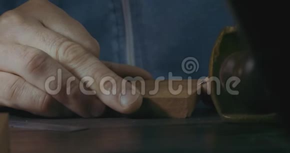 男性手的特写用铅笔标记木制细节用于制作木制胡子梳子手工工艺品制造木制视频的预览图