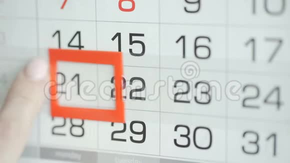 女人在墙上的日历上交办公室更改日期变动21至22视频的预览图