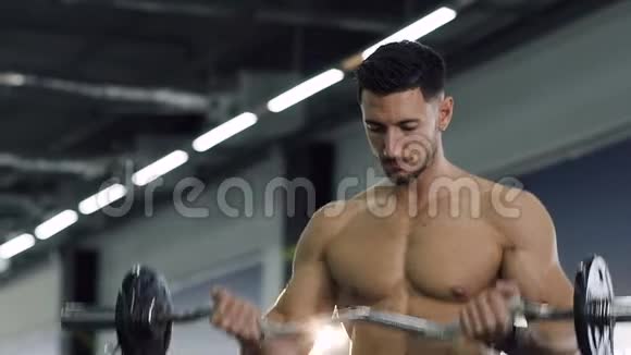 帅哥适合在健身房用杠铃做手臂肌肉锻炼视频的预览图