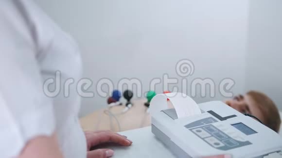 一家医疗诊所接受心电图检查的人从机器里出来的结果磁带视频的预览图