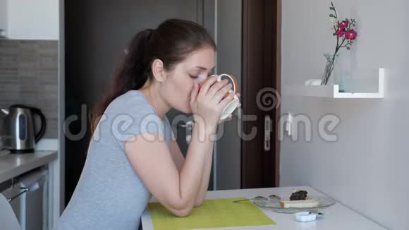 年轻的女旅行者正在酒店房间里吃早餐视频的预览图