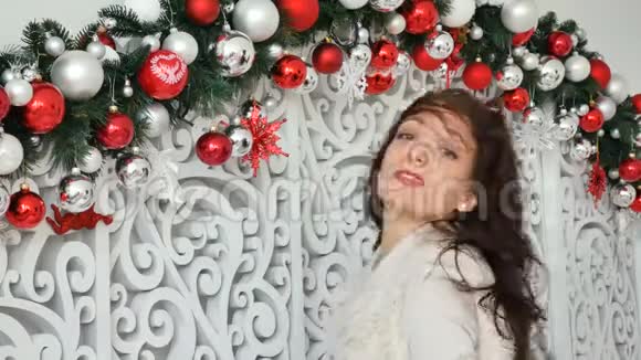 一个明亮卷曲的黑发肖像背景是圣诞装饰与银和黑球视频的预览图