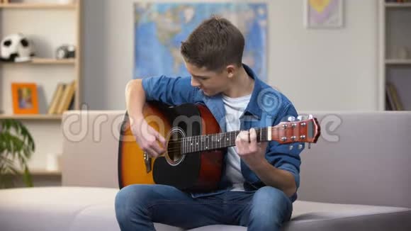 开朗的白种人少年弹吉他享受最喜欢的爱好休闲视频的预览图