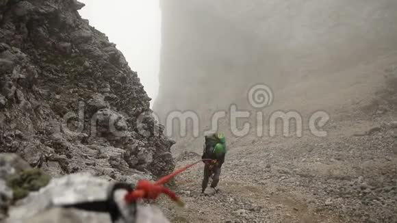 一个人抱着绳子爬山动作缓慢视频的预览图