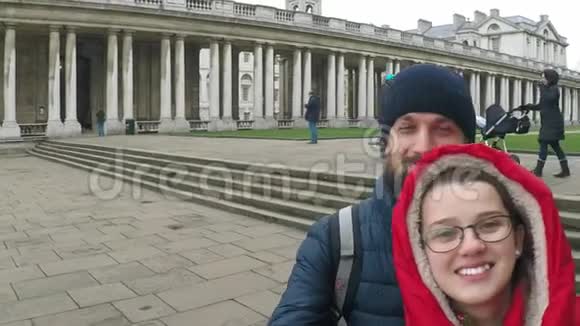 两个年轻人一个男的和一个女的正以古典风格和一个大柱廊走在伦敦附近视频的预览图