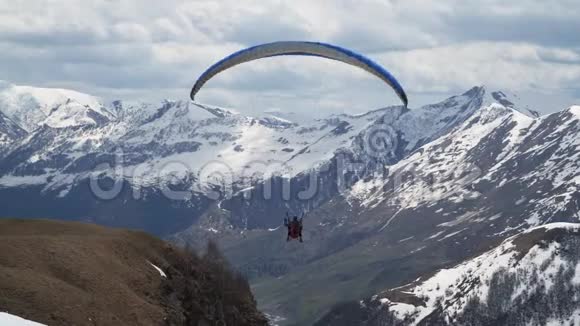 雪山背景下的滑翔伞视频的预览图