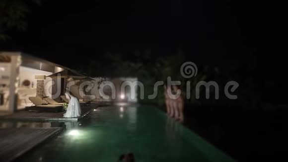 新娘在婚礼上扔了一束花晚上的泳池派对视频的预览图