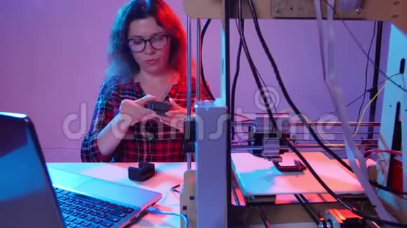 现代生产技术的概念年轻女子在3D打印机上打印模型视频的预览图