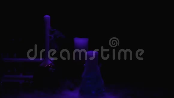 烧瓶中的有毒物质在蓝光下冒泡和散发烟雾视频的预览图