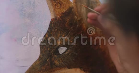 艺术家在她的车间里用丙烯酸颜料在画布上画画女孩艺术家画一只狐狸图片特写2视频的预览图