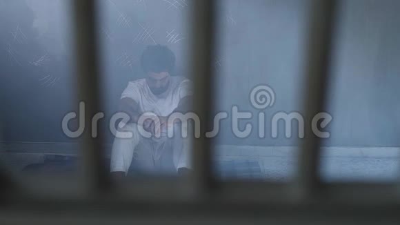 坐在监狱里的一个受压迫的人视频的预览图