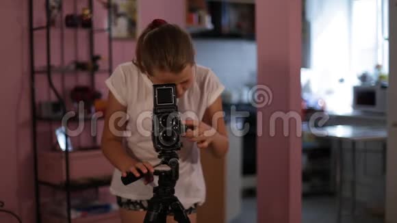 十几岁的女孩看着我的一个中型相机瞄准我们拍摄你的照片中型格式视频的预览图