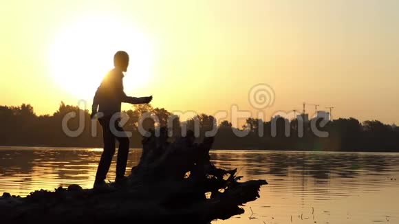 迪斯科人在金色的夕阳下跳上湖岸视频的预览图