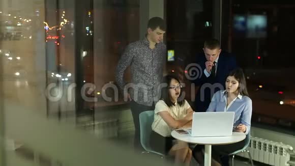 员工上班晚在玻璃办公室的笔记本电脑讨论视频的预览图
