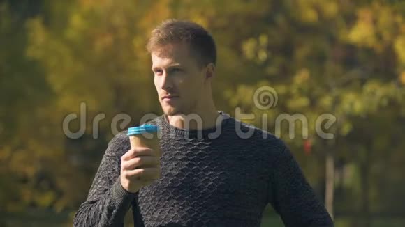 男子在秋季公园喝咖啡想着开始目标视频的预览图