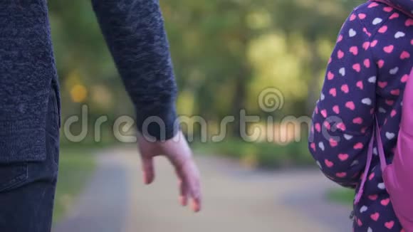 单亲父女牵手并肩前行秋视频的预览图