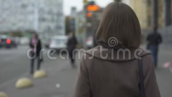 女人慢慢地走到公共汽车站有规律的工作方式公共交通视频的预览图