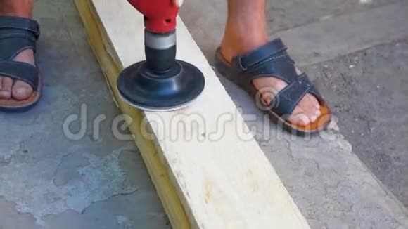 一个人用钻头上的喷嘴擦板用砂纸打磨木质木材视频的预览图