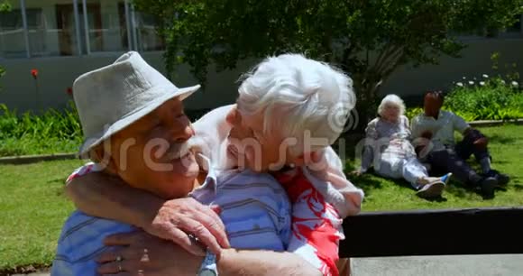 积极的高加索老夫妇在养老院花园拥抱对方的正面景色视频的预览图