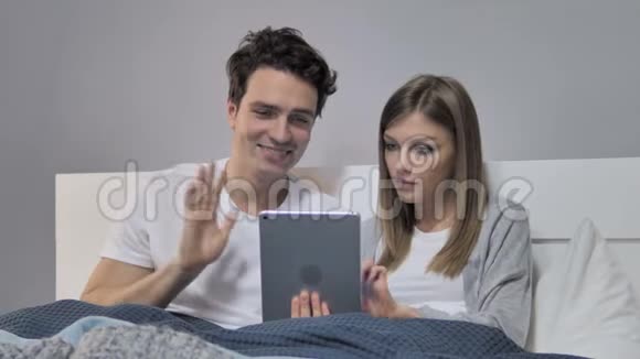 通过平板电脑在线视频聊天的年轻情侣视频的预览图