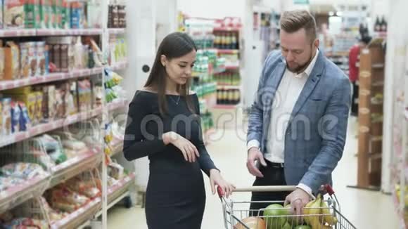 正面视频年轻夫妇女人在超市用水果做滑稽的脸视频的预览图