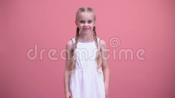 可爱的小女孩带着辫子展示心脏姿势慈善收养孩子视频的预览图