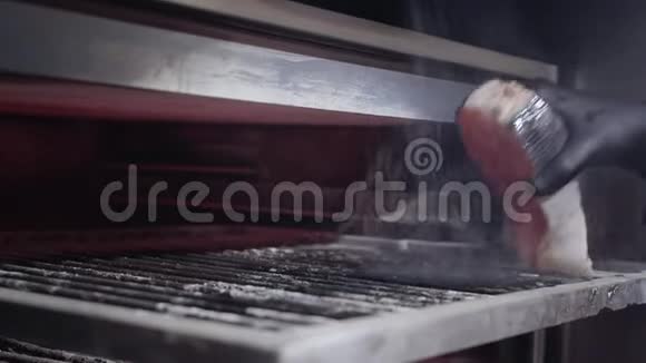戴上黑色手套把鱼三文鱼放在烤箱里并涂上烤焦视频的预览图