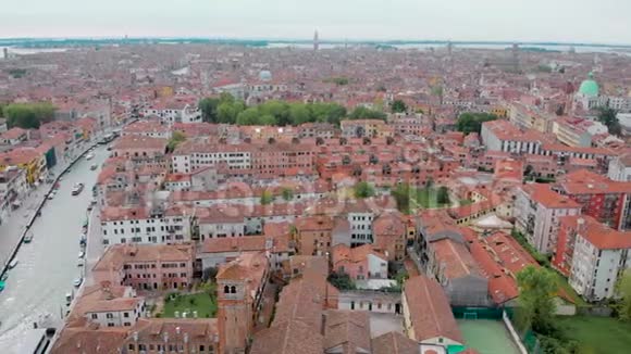 白天在空中俯瞰威尼斯无人机飞过令人惊叹的意大利城市红色屋顶和运河视频的预览图