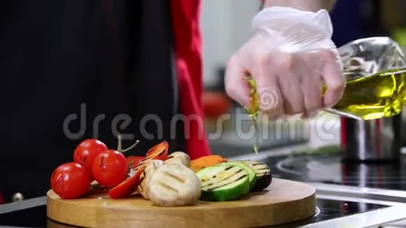 餐厅厨房两个人在做菜把橄榄油倒在上面视频的预览图