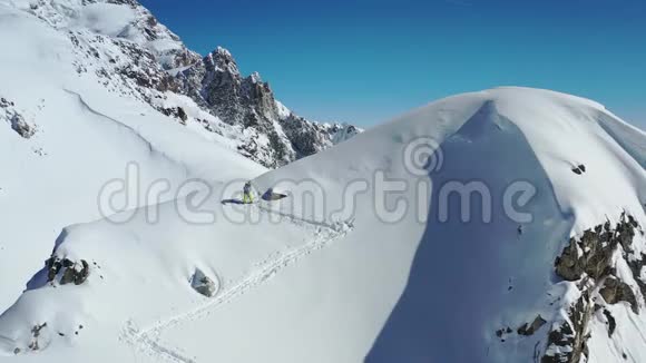极限运动一个人高速从滑雪板上的一座大山上自由行走空中拍摄的画面是4k视频的预览图