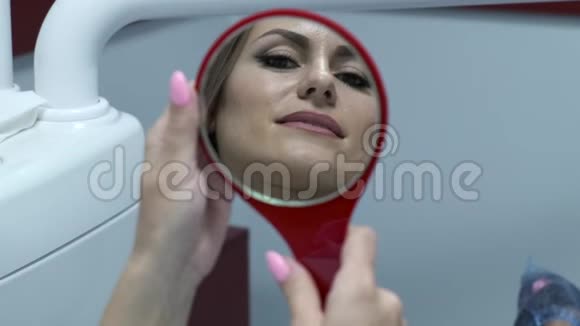 女性在镜子里检查牙齿视频的预览图